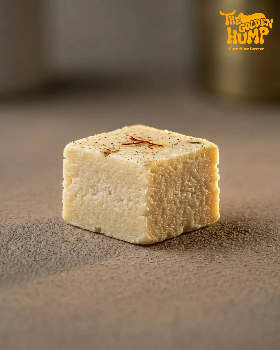 Badam barfi on a leaf-lidded round box with saffron strands