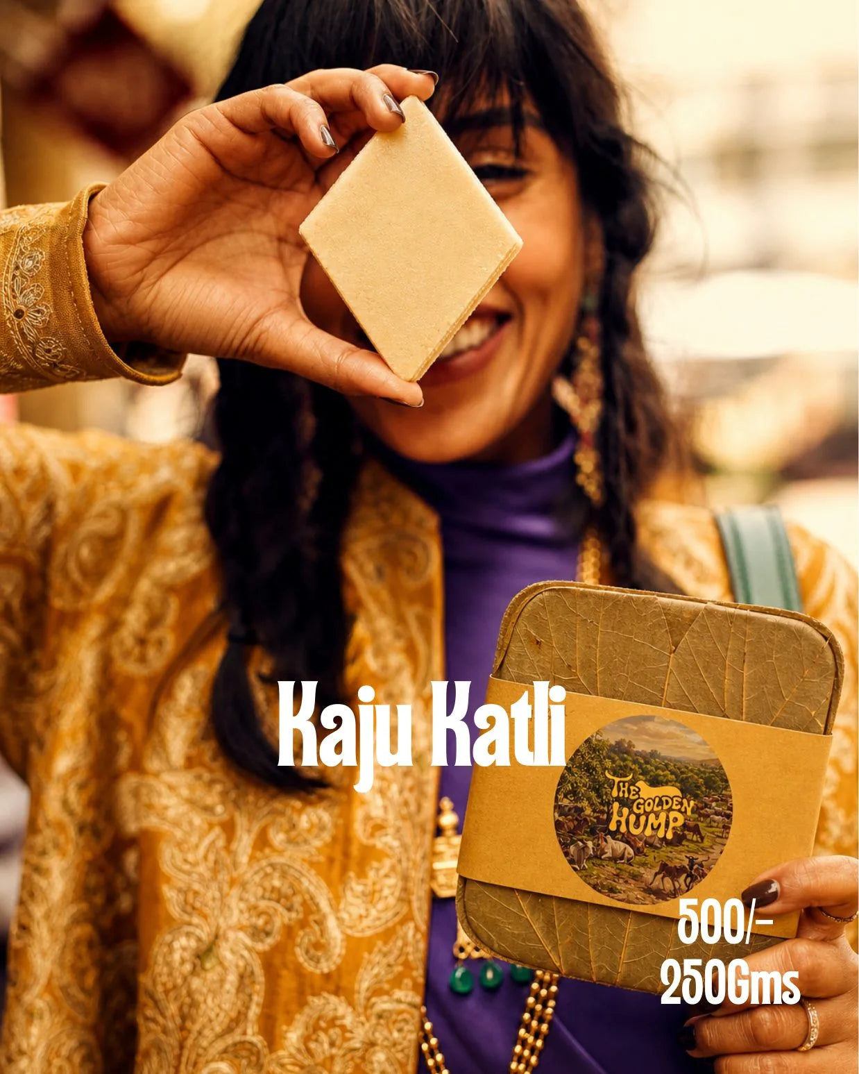 Woman holding a kaju katli diamond, with the Golden Hump leaf-lidded box